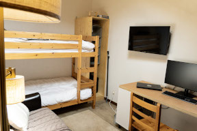Bunks space with a desk and storage